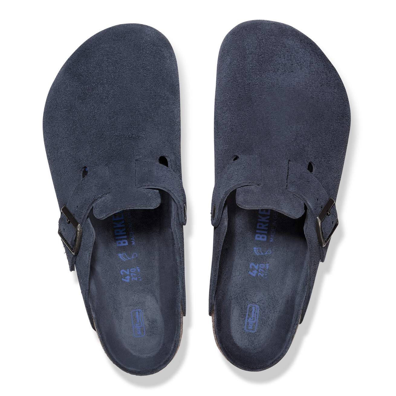 Navy blue suede clogs with adjustable strap, top view on white background